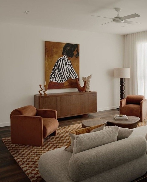 velvet armchairs, wooden sideboard, coffee table, area rug, sofa, floor lamp, brand awareness, lifestyle, minimalist, calm, luxurious, brown, neutral